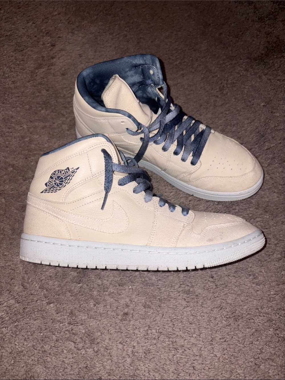Jordan 1 Women’s High Top Sneakers in Cream with Blue Accents